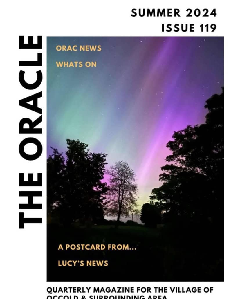 Cover of "The Oracle" magazine with a photo of colourful northern lights above silhouetted trees.